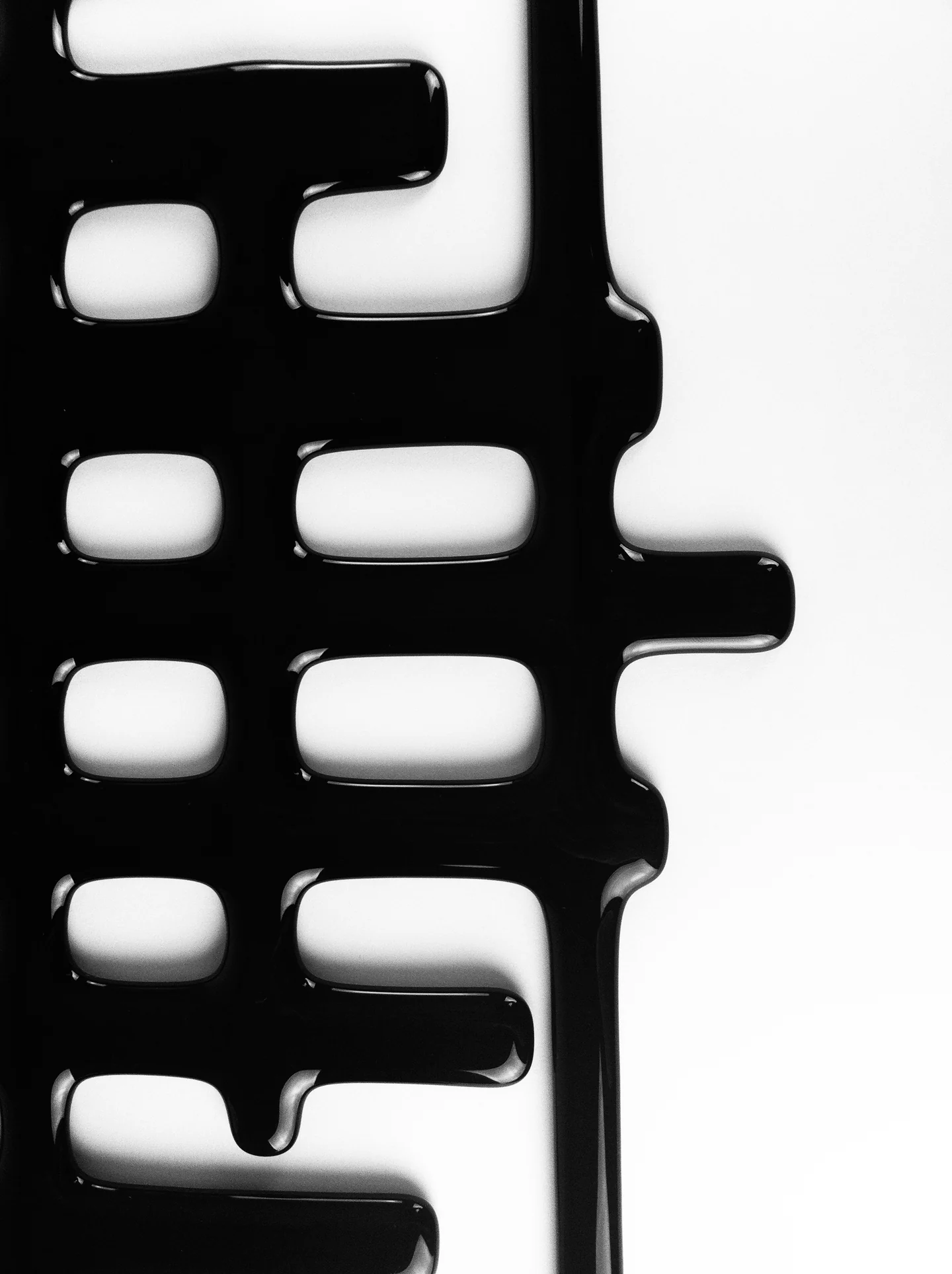 Black glass grid detail extending from the left against a pale background