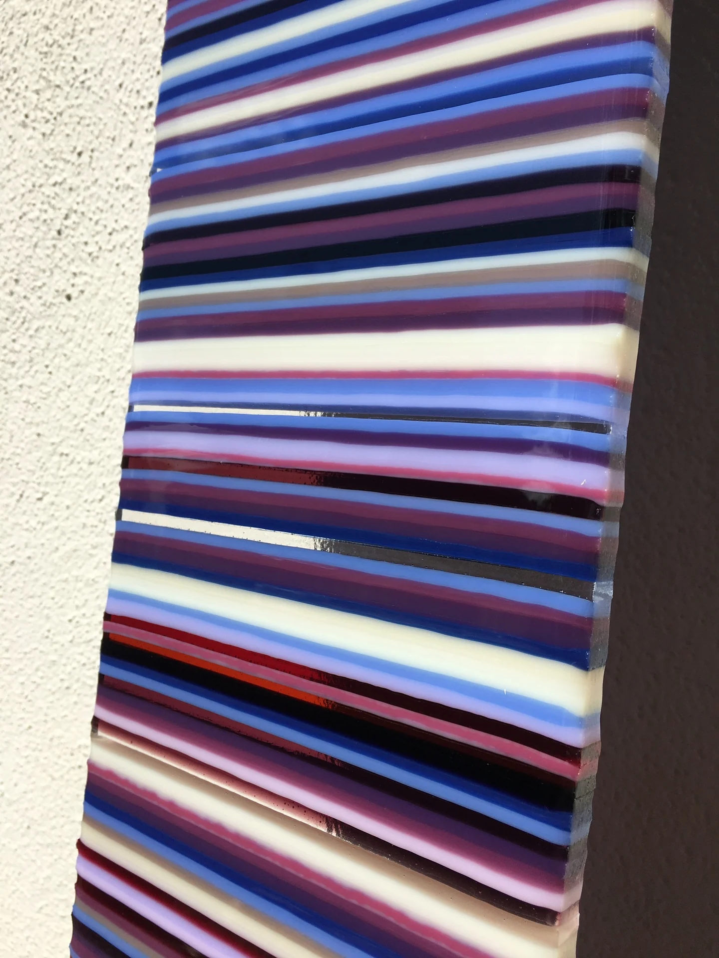 Close view of purple, blue and white horizontal stripes on a panel