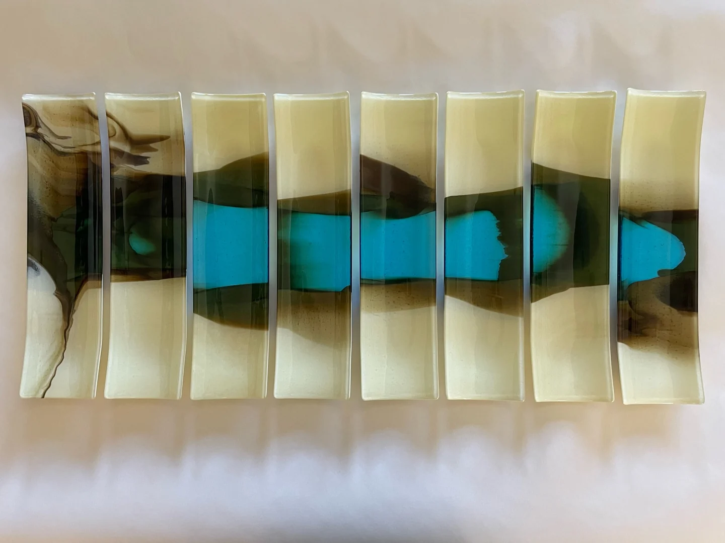 A row of narrow pale vertical strips carries a dark and bright blue horizontal pattern across its middle.