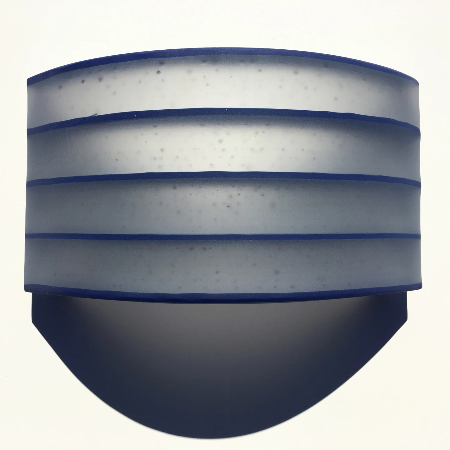 A close frontal view shows blue-gray horizontal bands above a smooth dark semicircular lower section.