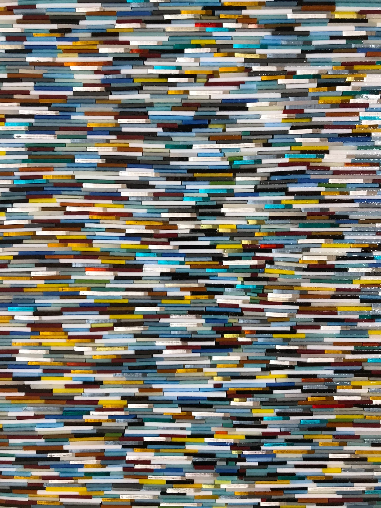 Close view of densely layered, multicoloured glass strips