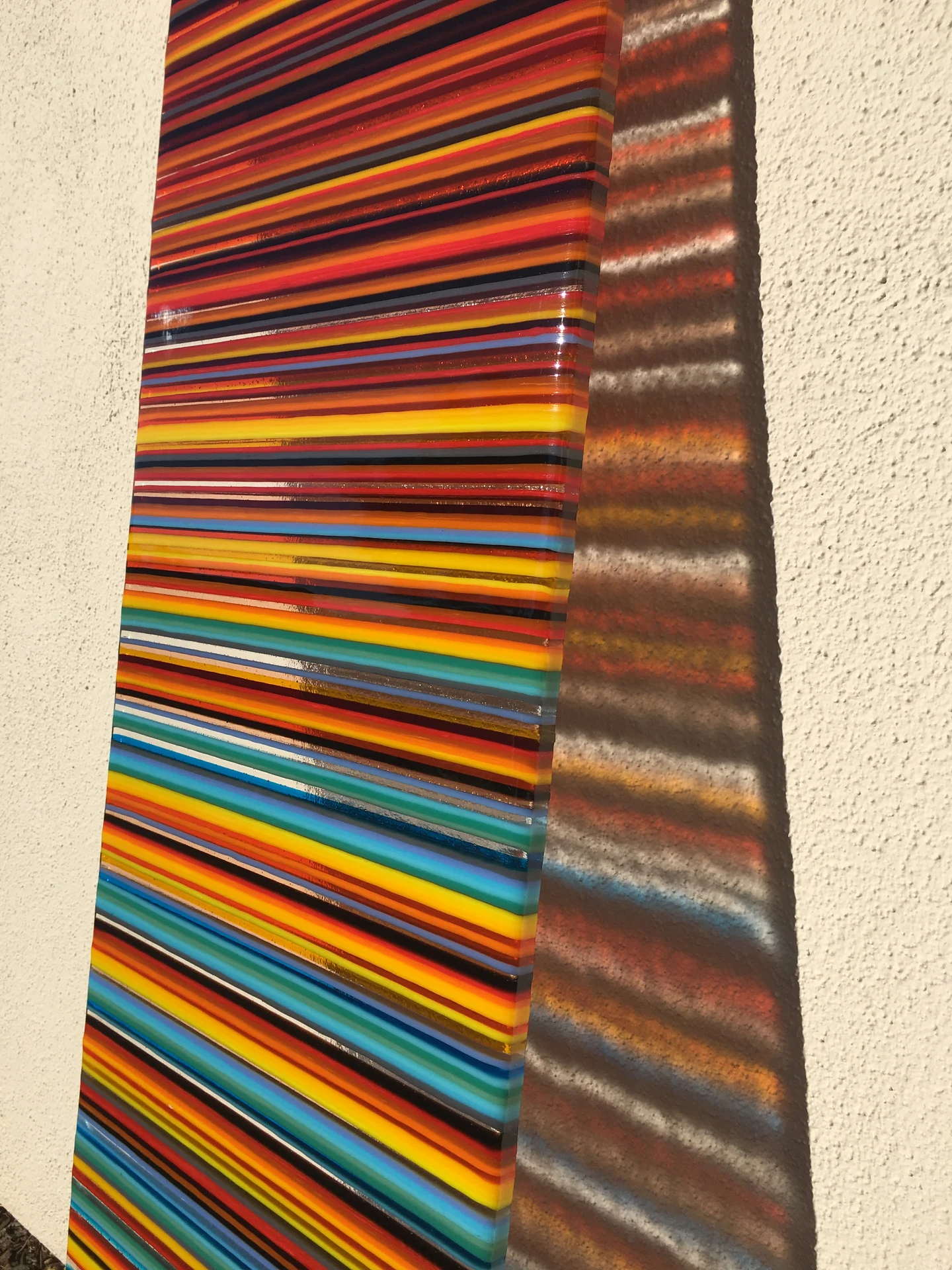 Close angled view of colourful glass stripes